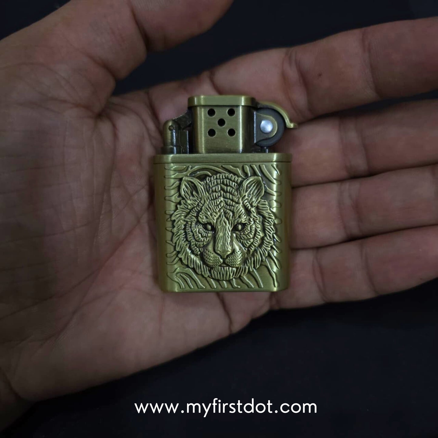 Gold lighter with tiger design held in a hand, brand 'myfirstdot' visible