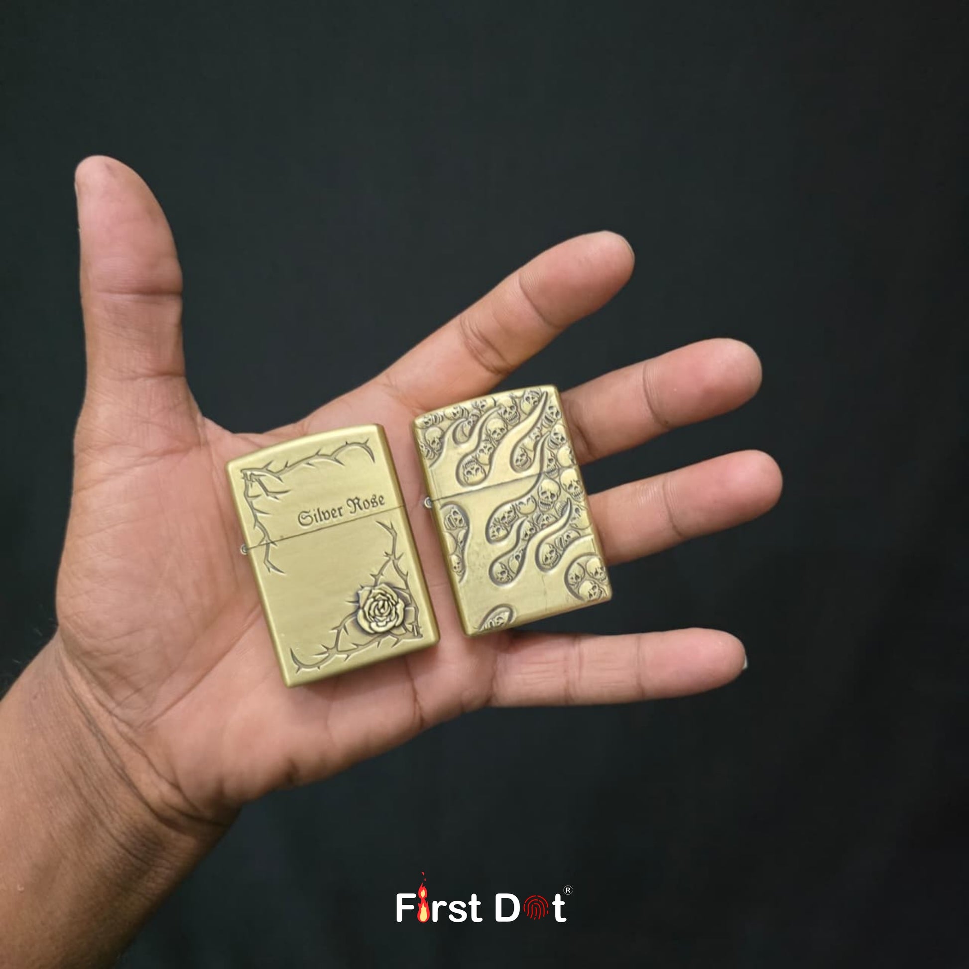 Two gold lighter cases held in a hand against a black background, with 'First Dot' branding.