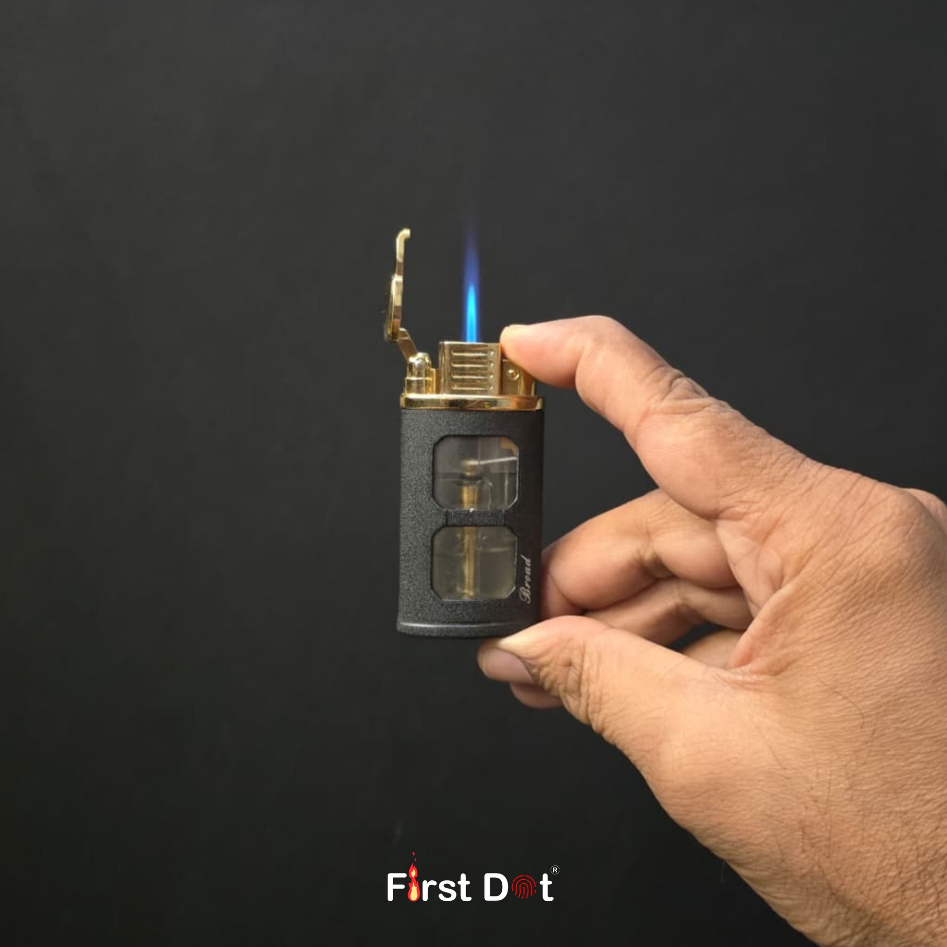 Hand holding a lighter with a flame against a black background, featuring the 'First Dot' brand.