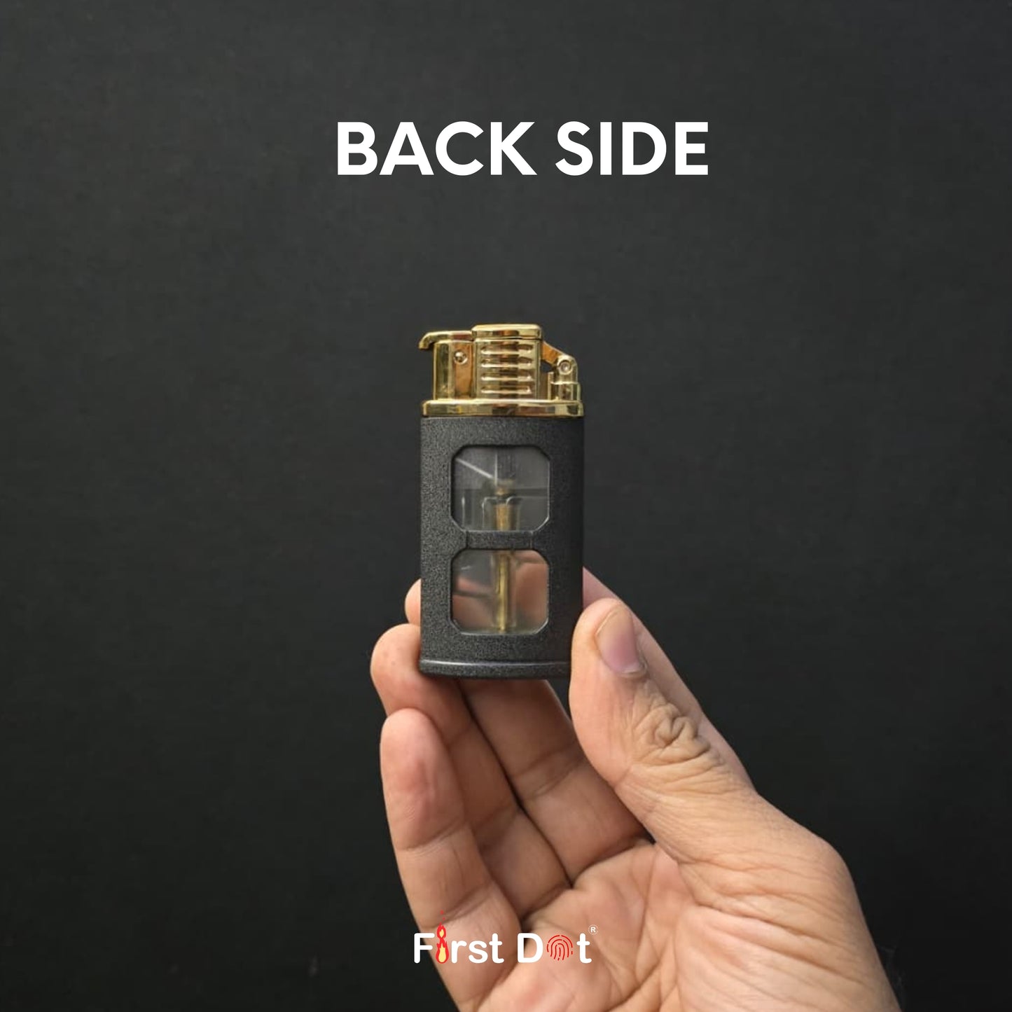 Hand holding a black and gold lighter with 'First Dot' branding on a dark background