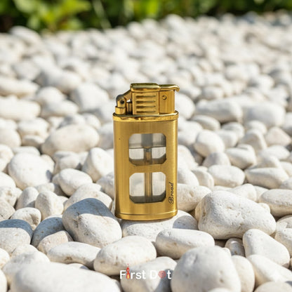 Gold lighter on pebbles with 'First Dot' branding