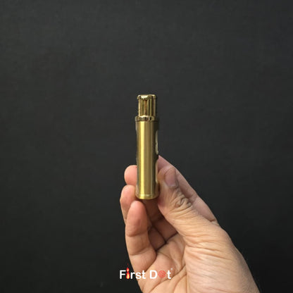 Hand holding a brass lighter against a black background