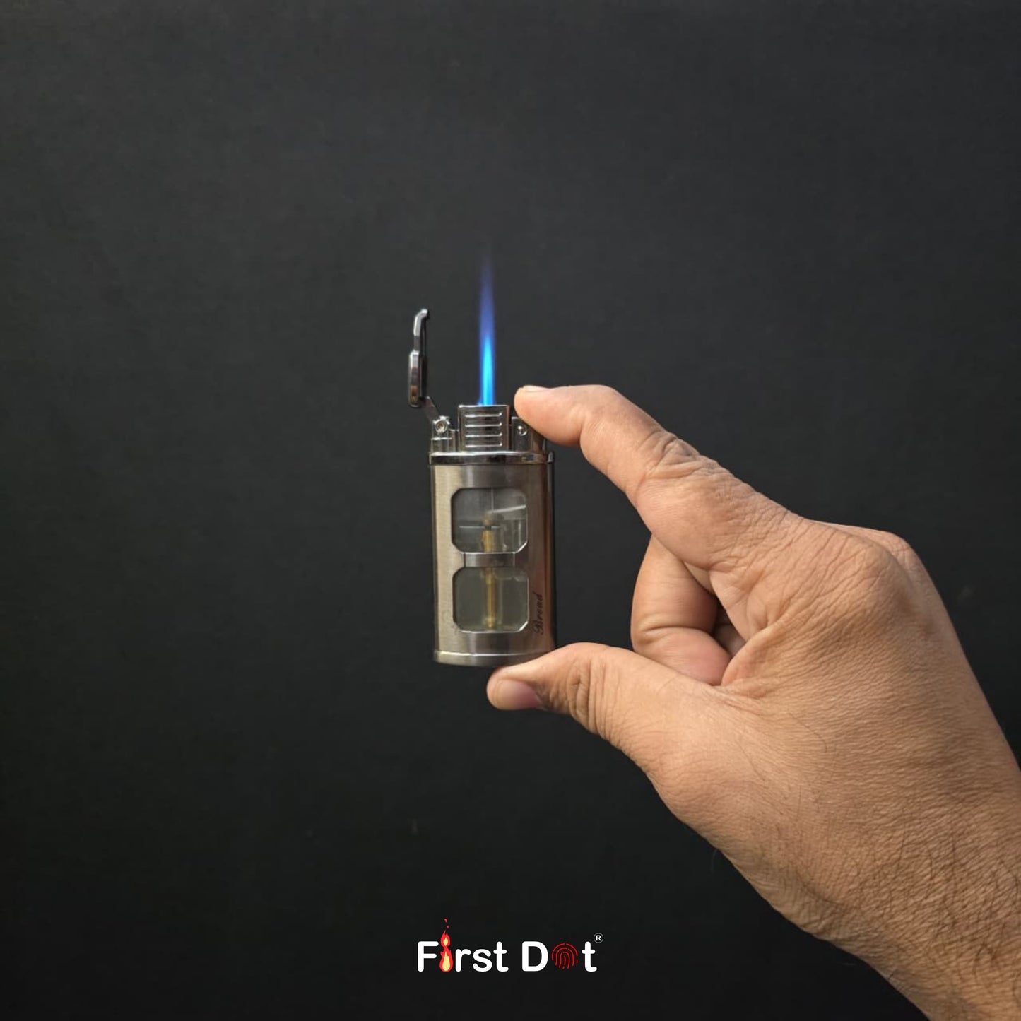 Hand holding a lit lighter with 'First Dot' branding against a dark background