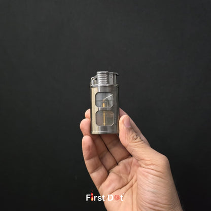 Hand holding a small metallic device against a black background with 'First Dot' branding.