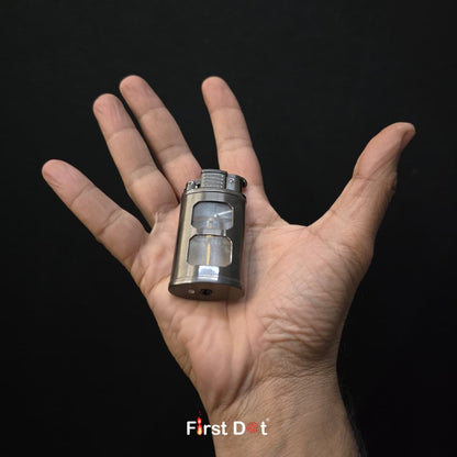 Small metallic object held in a hand against a black background with 'First Dot' branding.