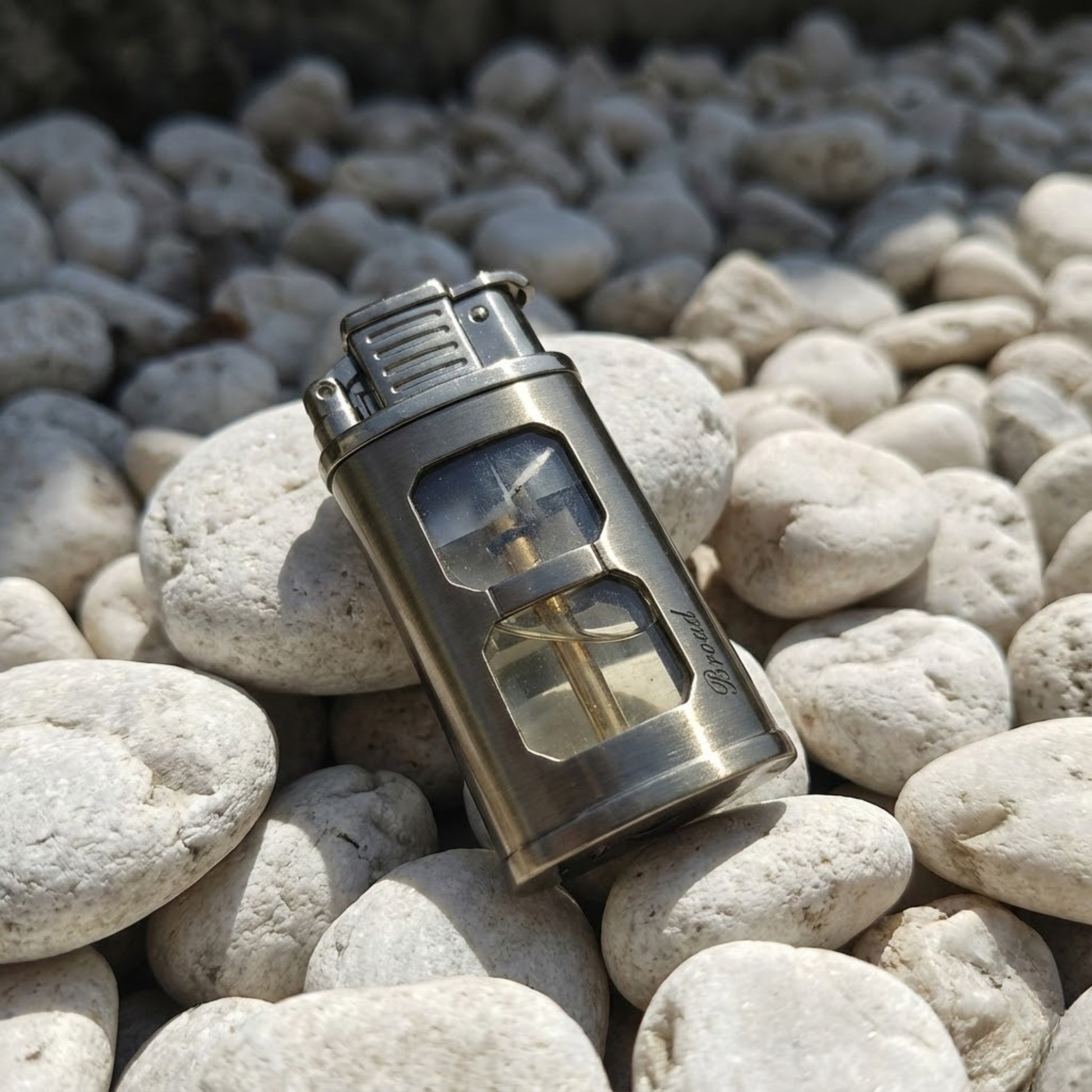 Metallic lighter on a bed of stones
