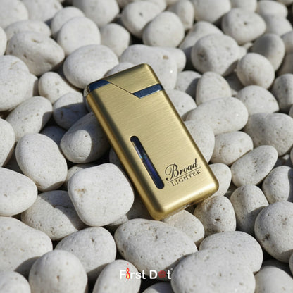 Gold lighter with 'Bread' branding on pebbles, featuring 'First Dot' logo.
