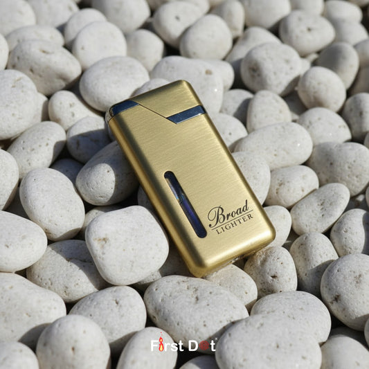 Gold lighter with 'Bread' branding on pebbles, featuring 'First Dot' logo.