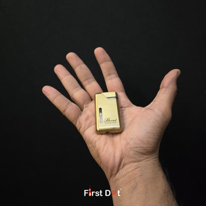Gold lighter held in a hand against a black background
