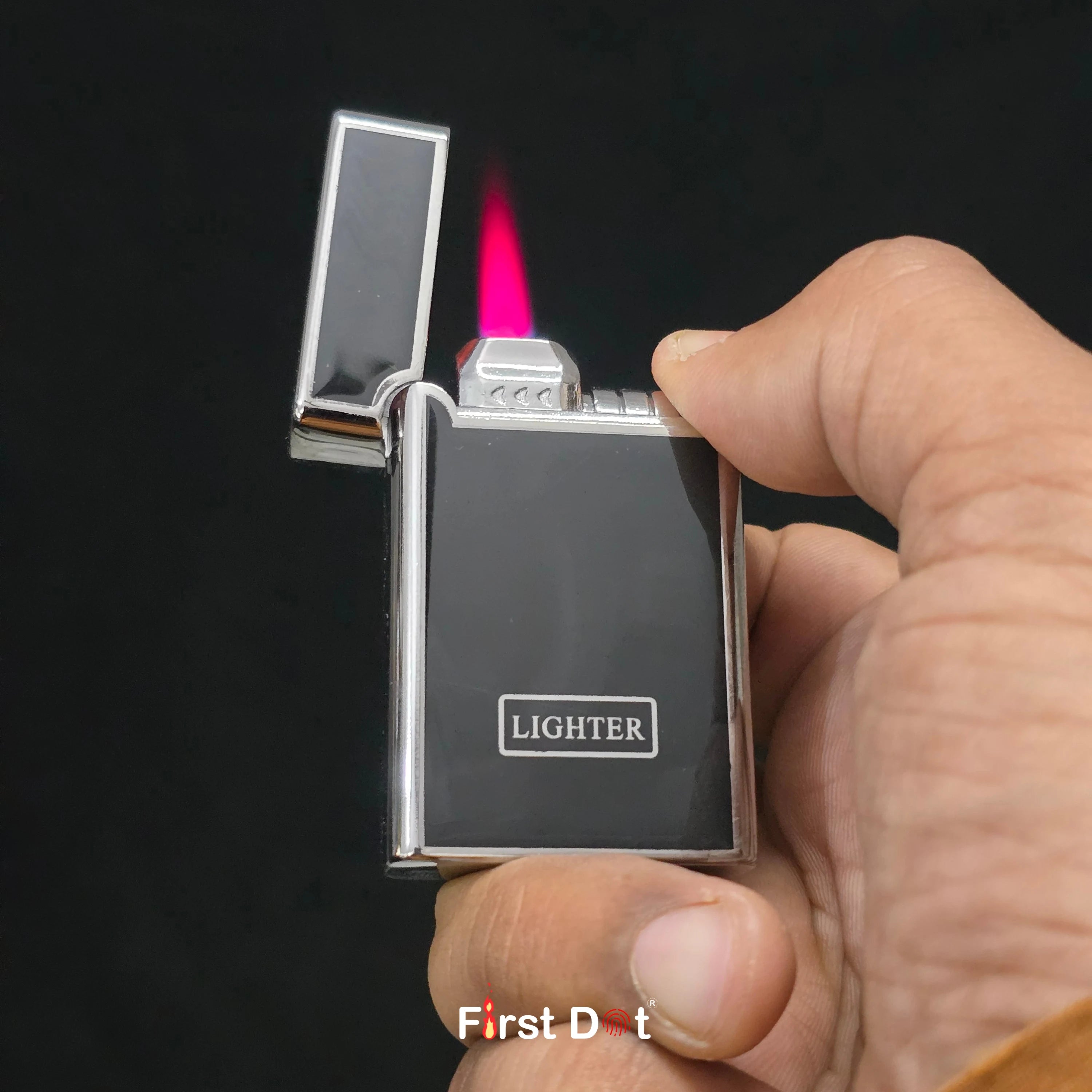 Hand holding a lighter with a lit flame against a dark background
