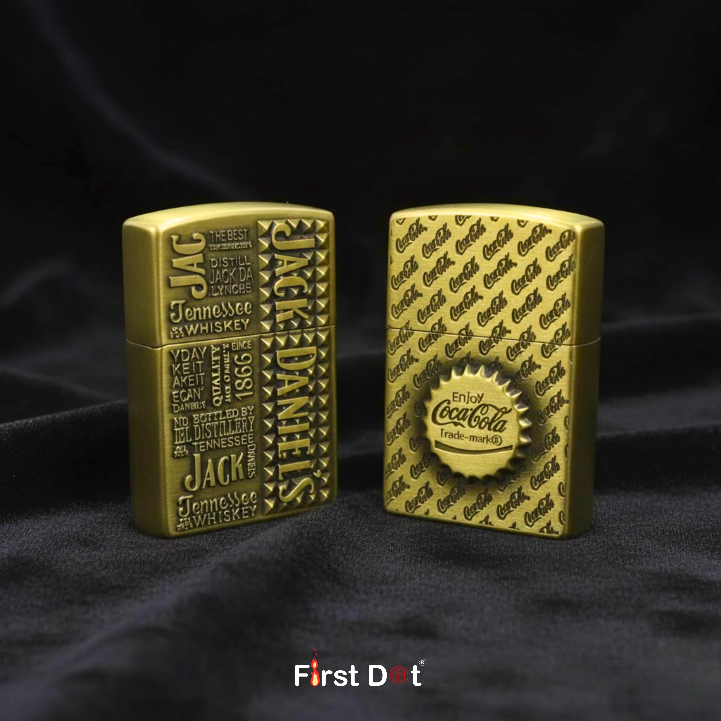 Two gold lighters, one with Jack Daniel's branding and the other with Coca-Cola branding, on a black background.