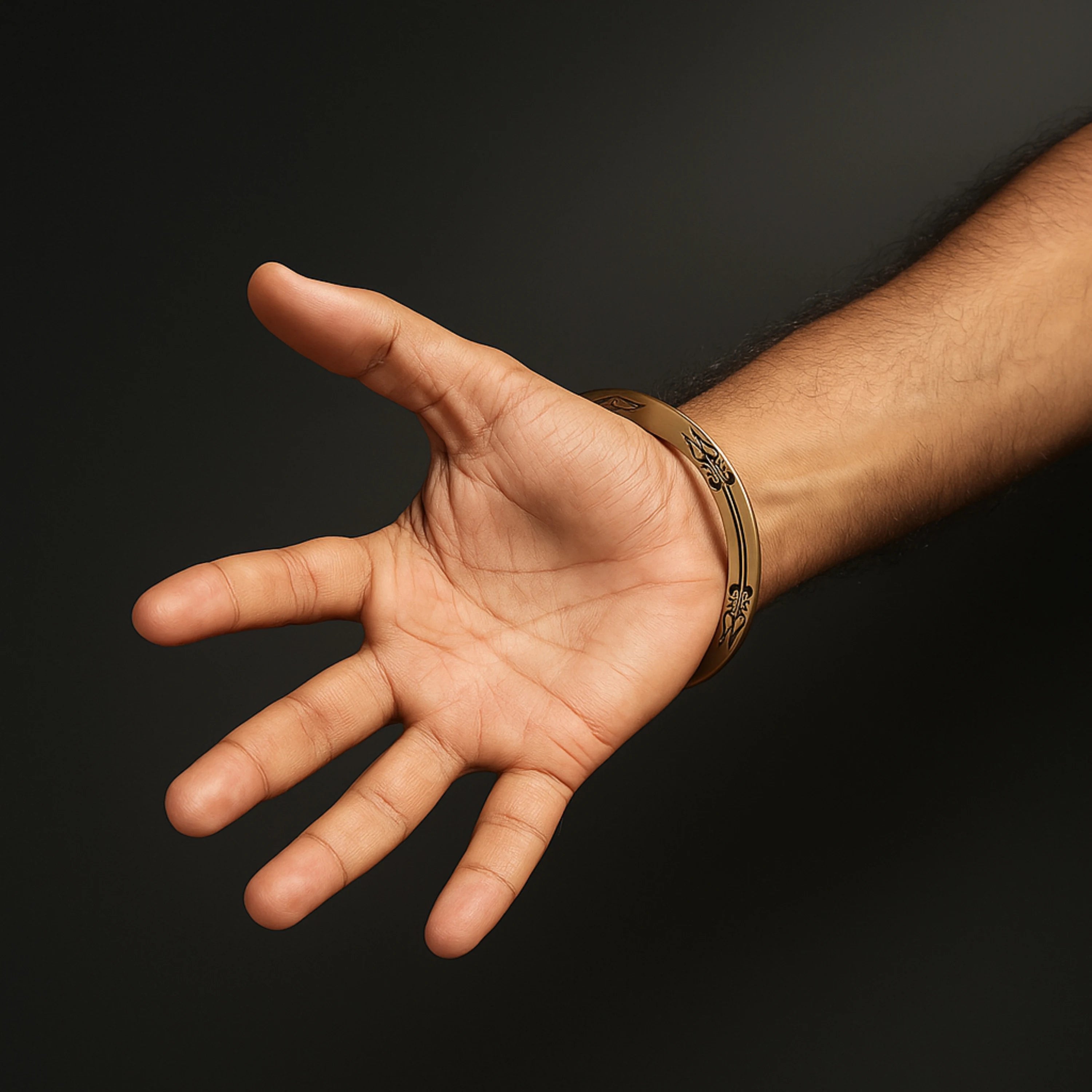 Hand with a bracelet on a dark background महाकाल Brass Kada