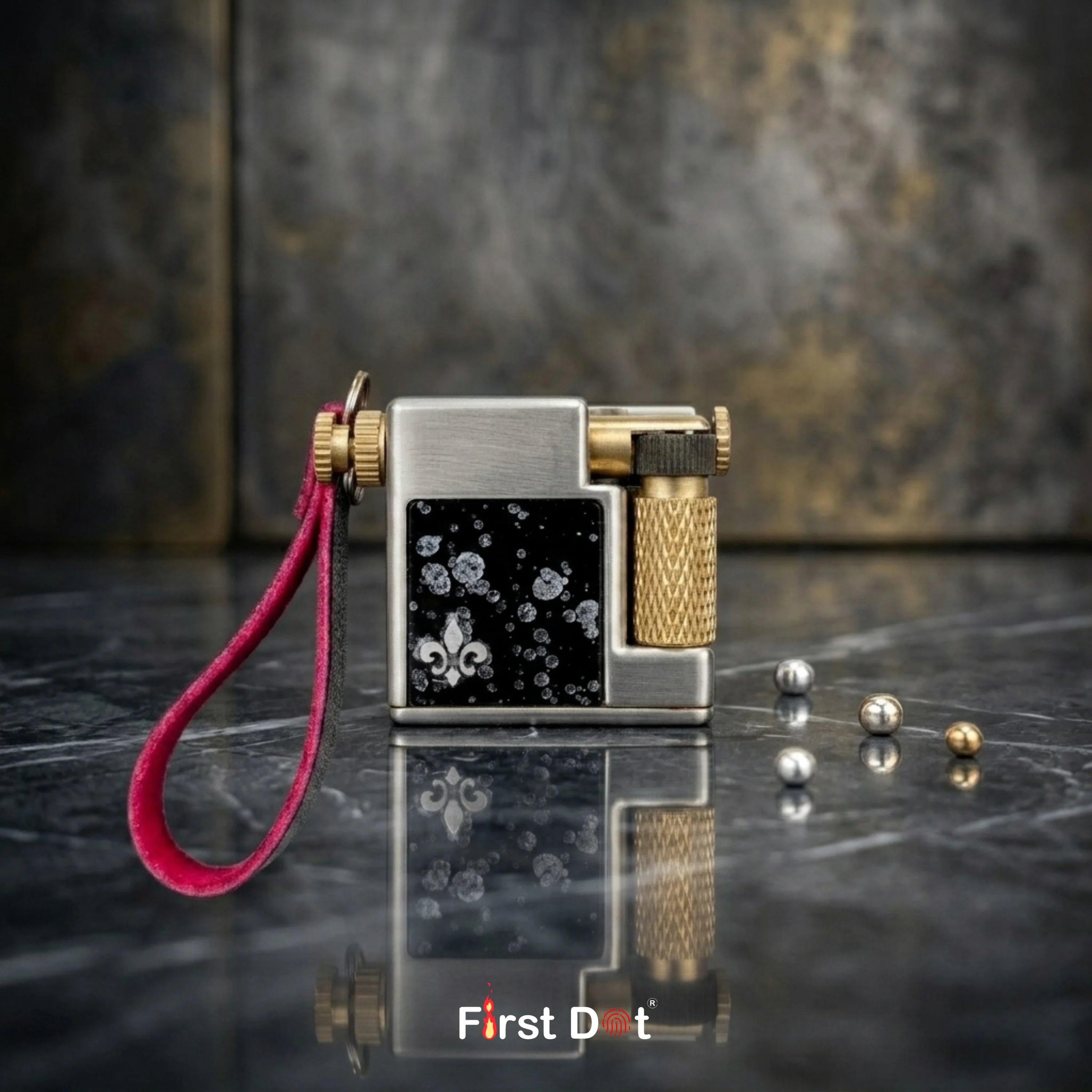 Luxury lighter with pink strap on a reflective surface, branded 'First Dot'.