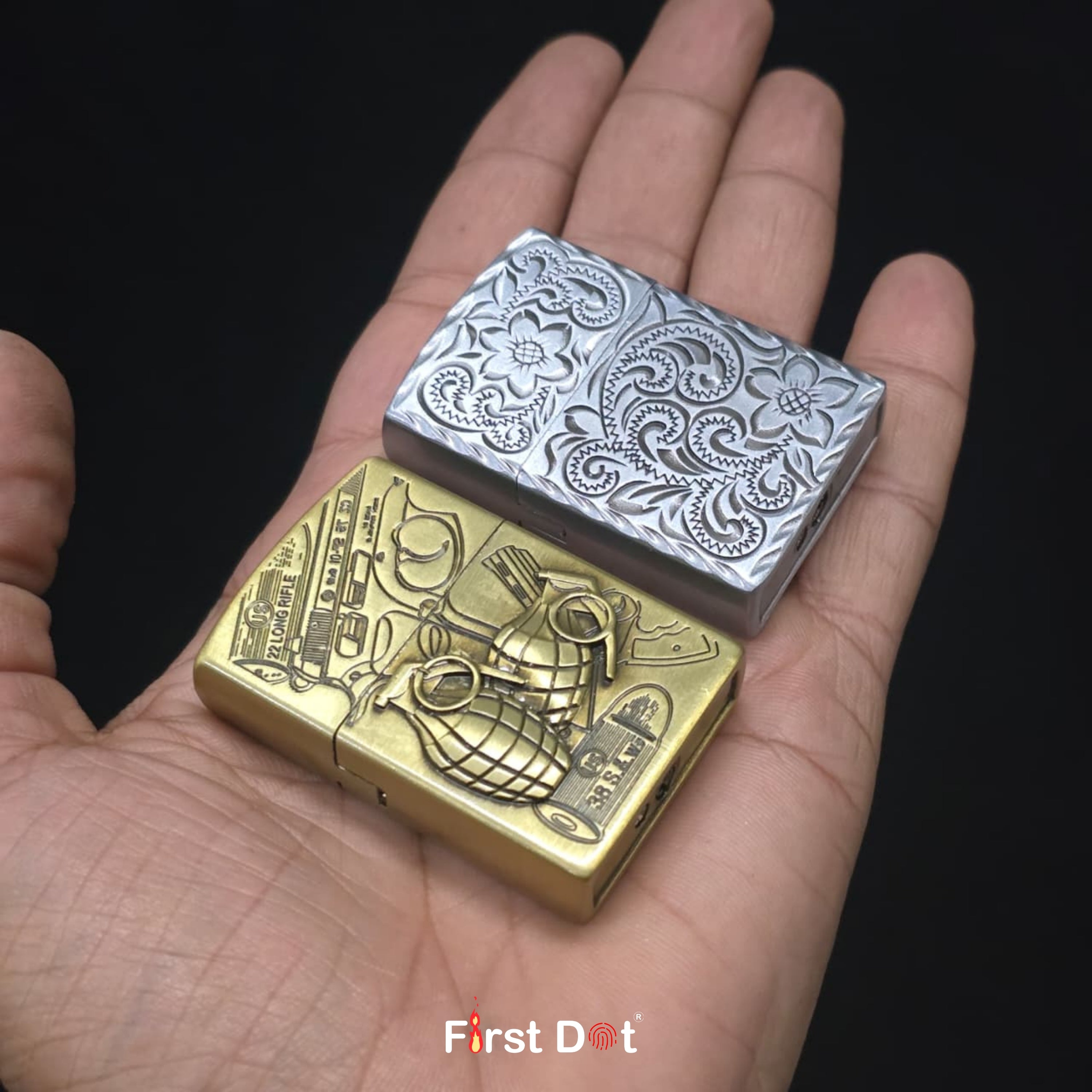 Two metallic lighters, one gold and one silver, held in a hand with 'First Dot' branding.
