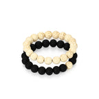 Two beaded bracelets, one with black beads and the other with cream-colored beads, on a white background. CrackleStoneBracelet