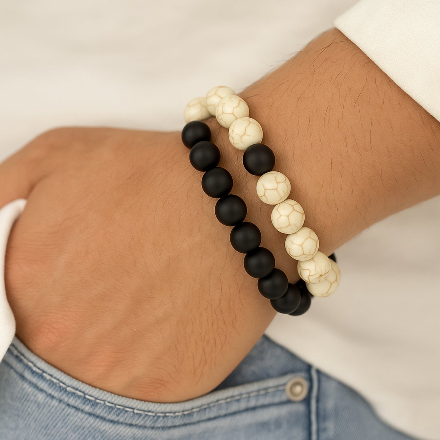 Black and white beaded bracelet on a wrist with a blurred background CrackleStoneBracelet
