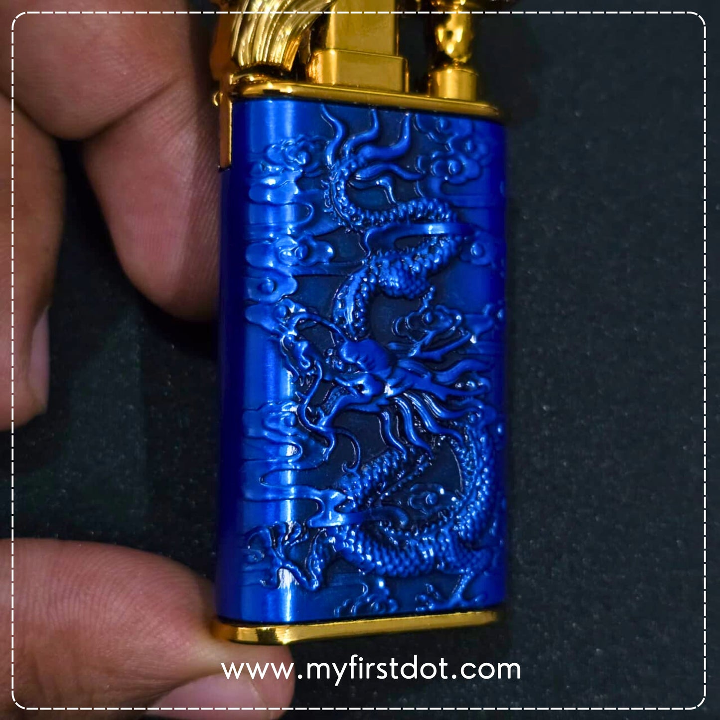 Blue lighter with dragon design held by a hand on a dark background