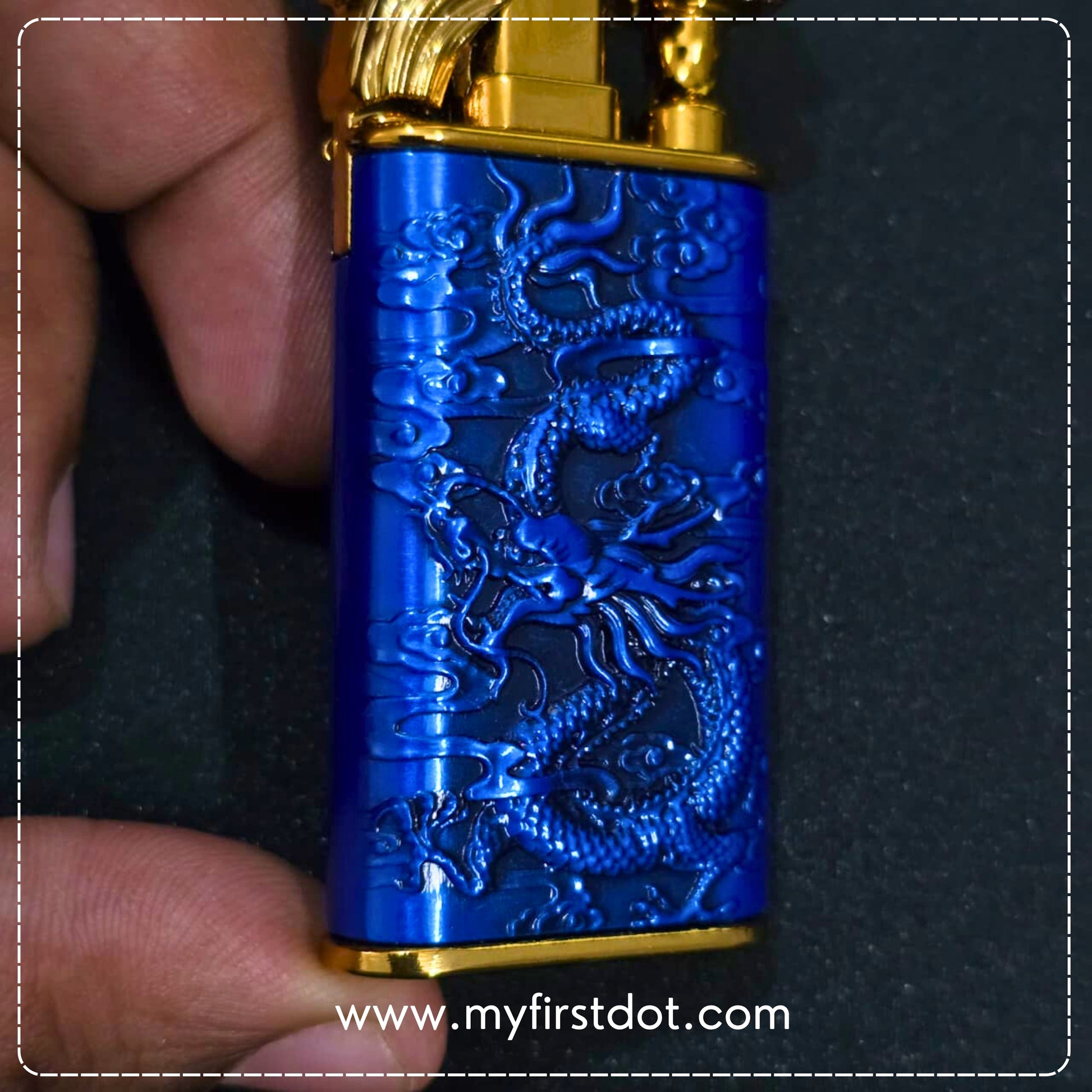 Blue lighter with dragon design held by a hand on a dark background