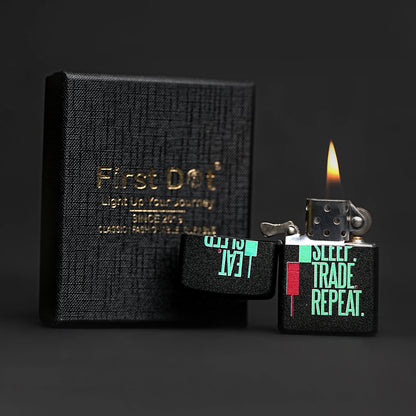 Black textured notebook with 'First Dog' branding and a lit lighter with text on a dark background Eat Sleep Trade Repeat Candle Premium Refillable Cigarette Lighter
