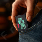 Hand holding a Zippo lighter with 'Eat Sleep Trade Repeat' text against a blurred background Eat Sleep Trade Repeat Candle Premium Refillable Cigarette Lighter