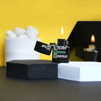 Two black lighters with text on a black stand against a yellow background Eat Sleep Trade Repeat Refillable Cigarette Lighter