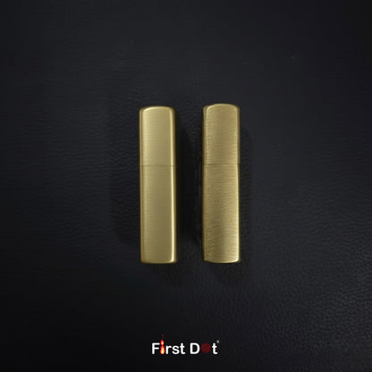 Two gold lighters on a black textured background with 'First Dot' branding.