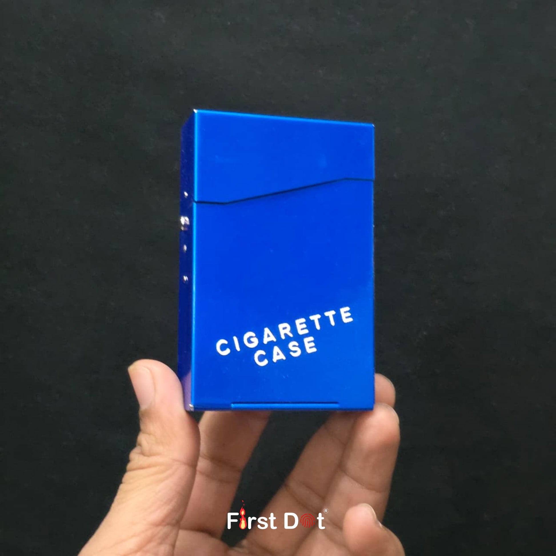 Blue cigarette case held in a hand against a black background