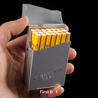 Hand holding a gray cigarette case with yellow cigarettes on a black background