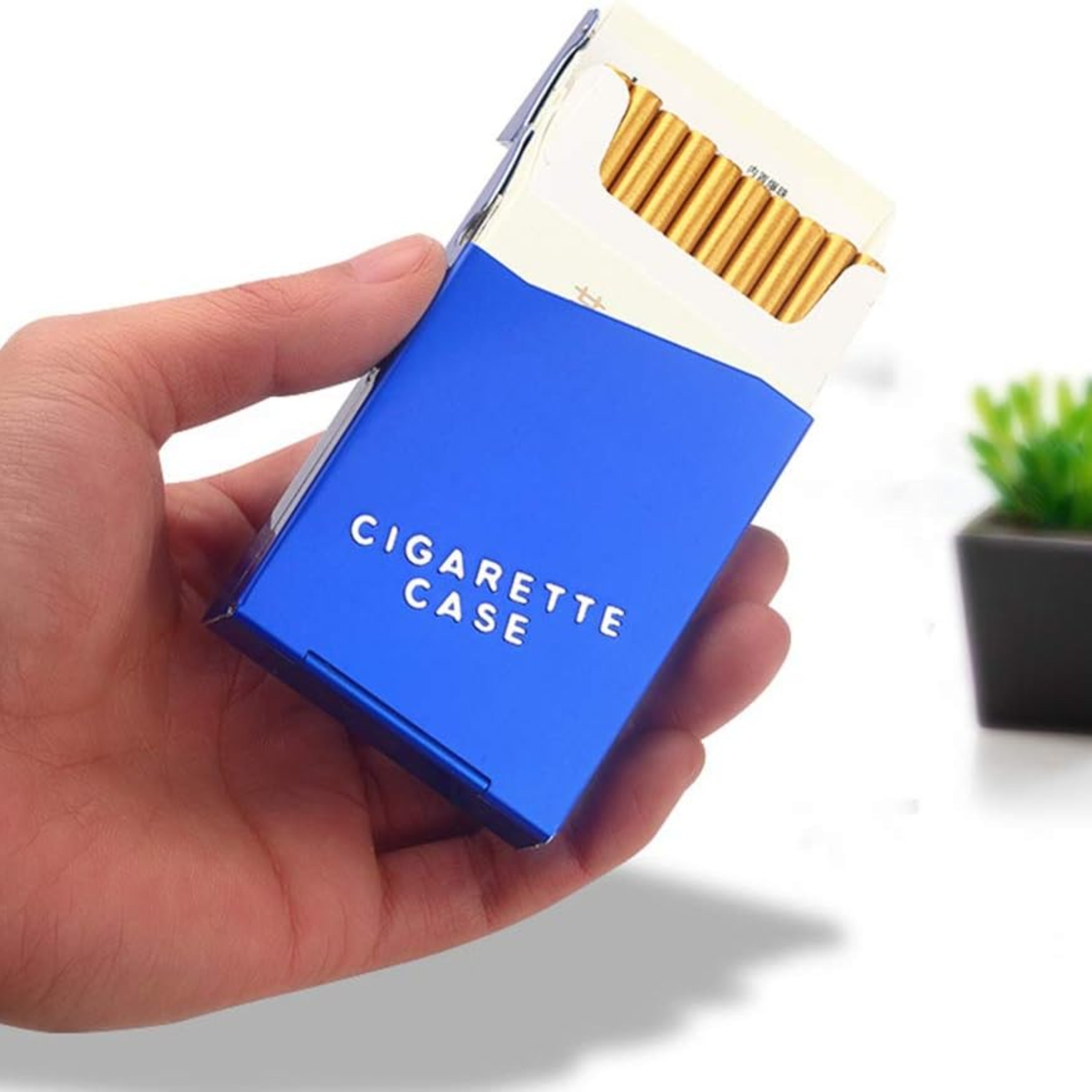 Blue cigarette case with gold cigarettes held in a hand, white background