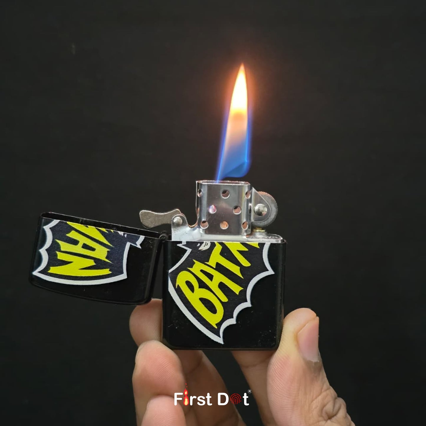 Lighter with 'Batman' branding being ignited against a dark background