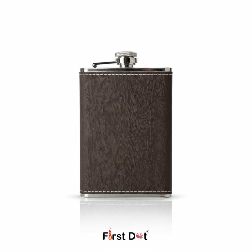 Brown leather flask with silver cap on a white background, branded 'First Dot'.