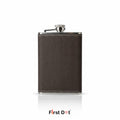 Brown leather flask with silver cap on a white background, branded 'First Dot'.