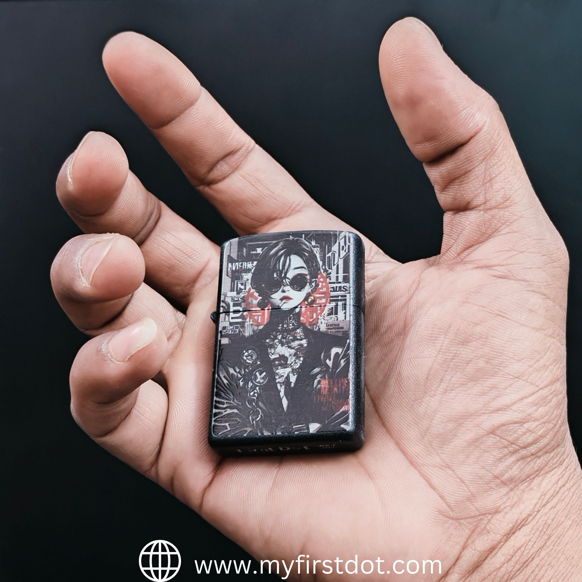 Hand holding a zippo lighter with a design on a black background