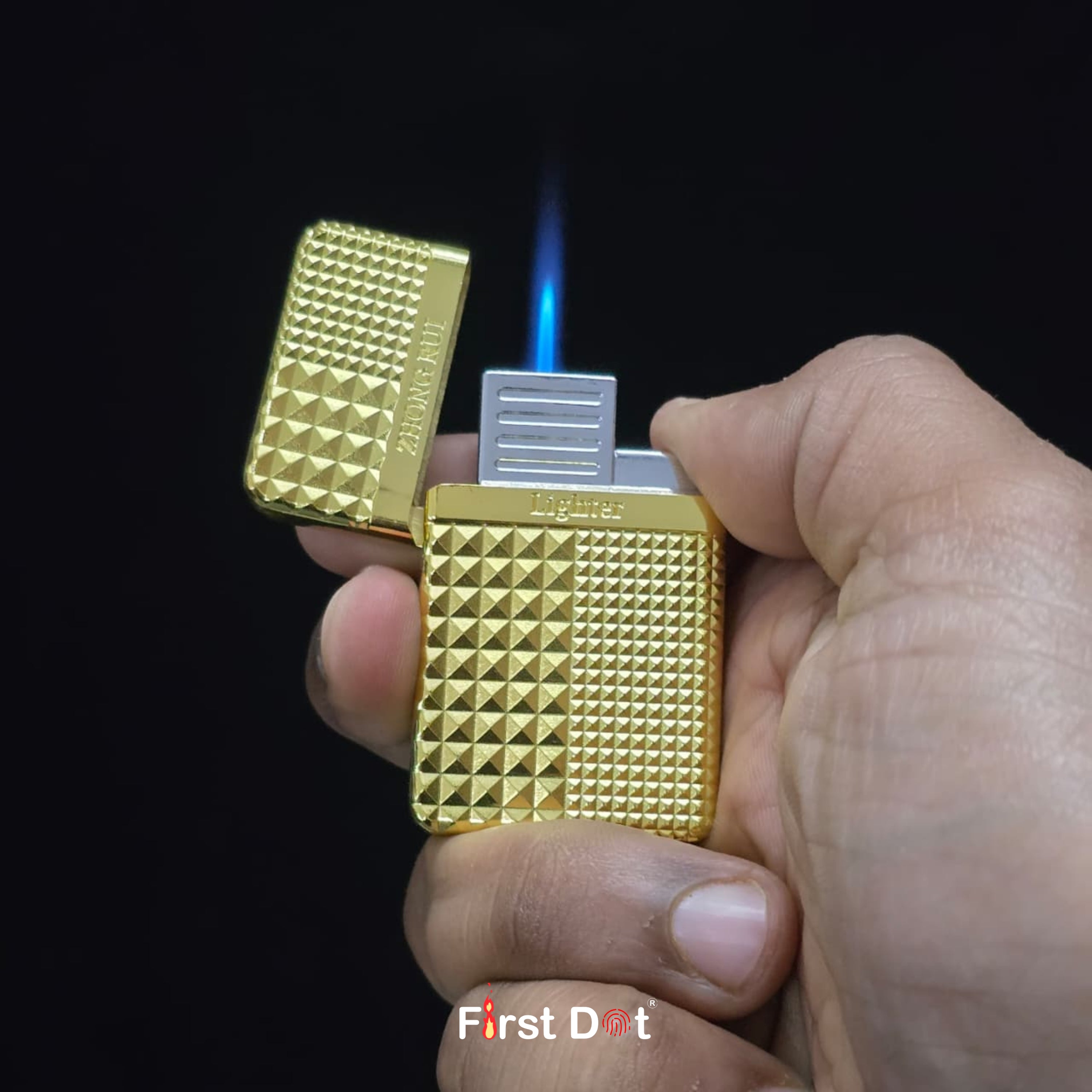 Gold lighter being ignited with a dark background Gold Diamond Cut Cigarette Lighter