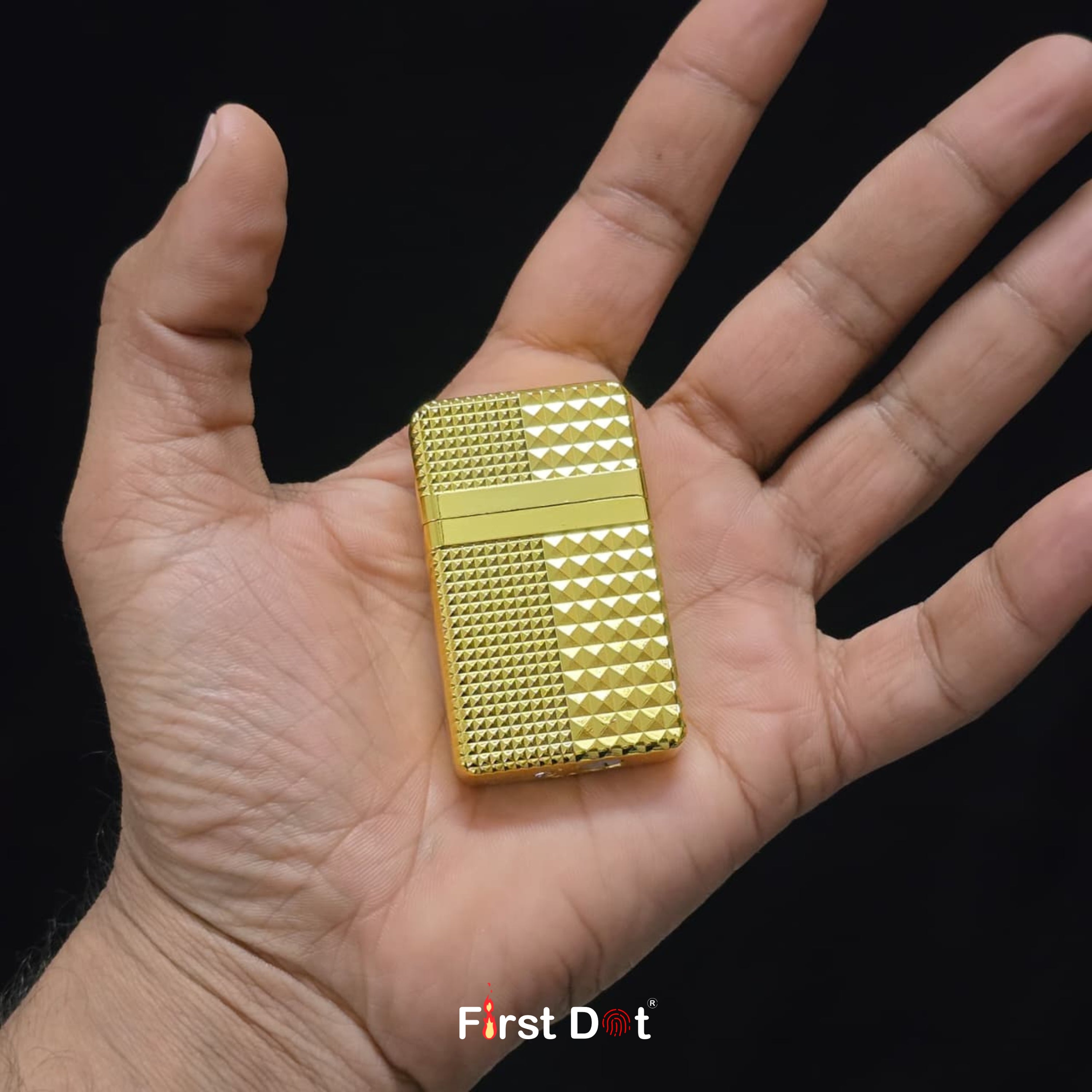 Gold lighter held in a hand with 'First Dot' branding.