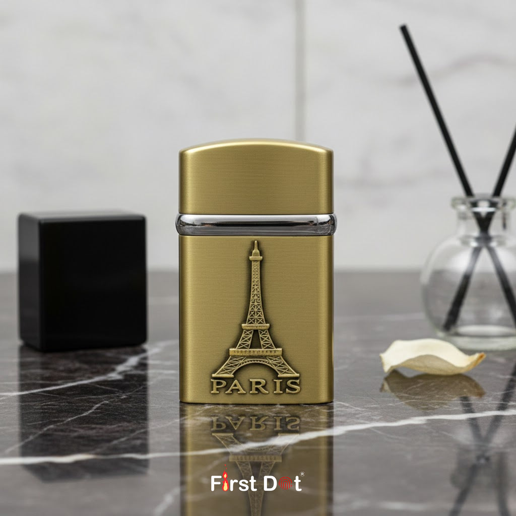 Gold lighter with Eiffel Tower design and 'Paris' text on a marble surface, branded 'First Dot'.