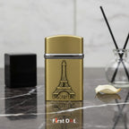 Gold lighter with Eiffel Tower design and 'Paris' text on a marble surface, branded 'First Dot'.