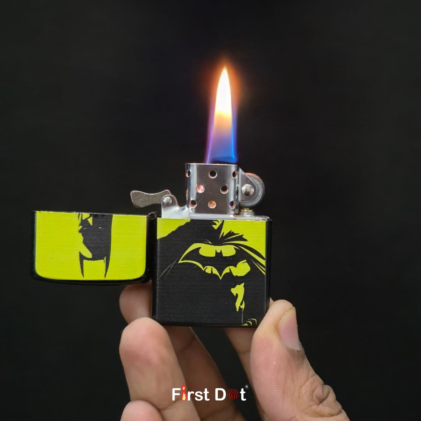 Lighter with Batman design being held, lit against a dark background