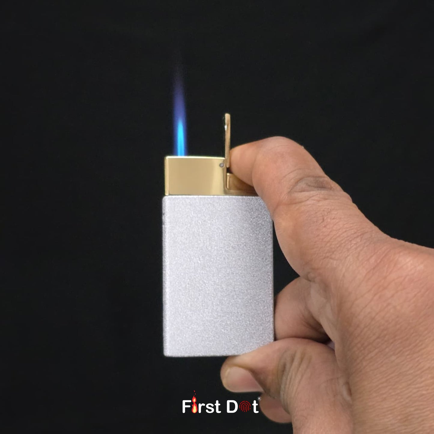 Hand holding a lighter with a flame against a black background, featuring 'First Dot' branding.