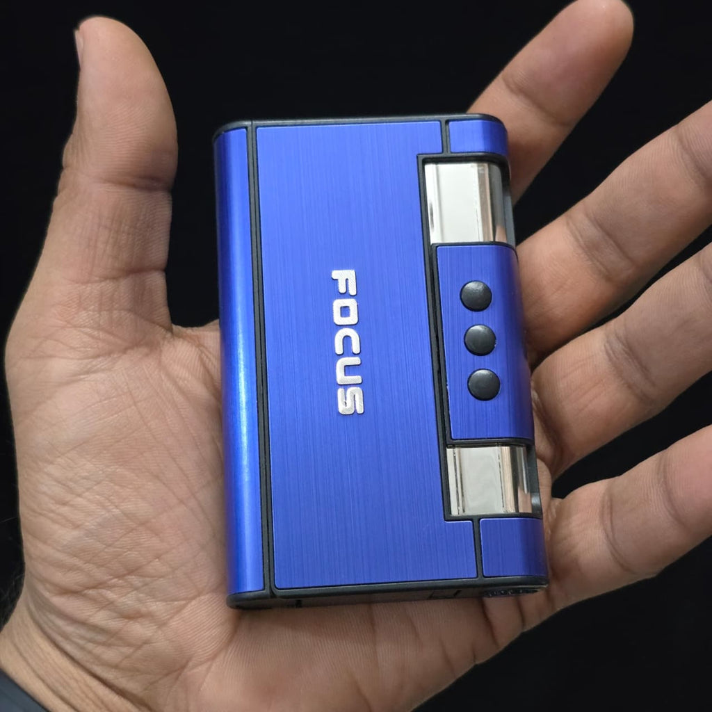 cigarette case with jet flame lighter  with 'FOCUS' branding held in a hand against a black background