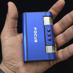 cigarette case with jet flame lighter  with 'FOCUS' branding held in a hand against a black background