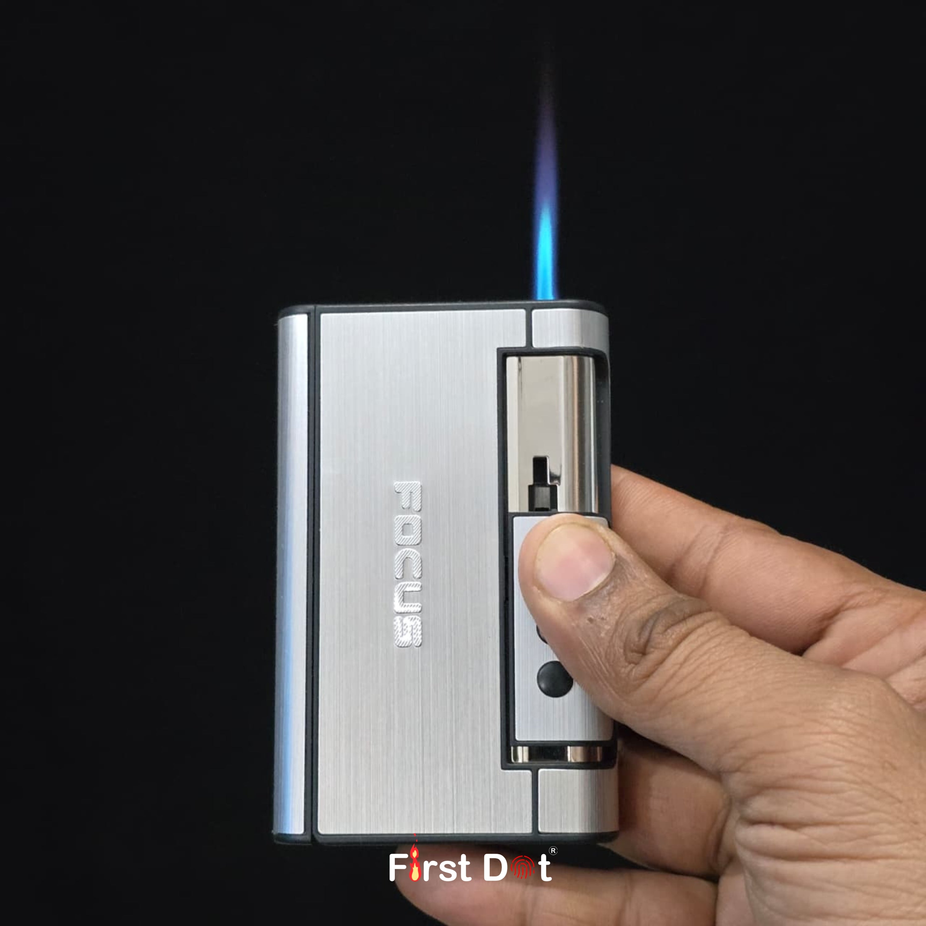 Hand holding a silver lighter with blue flame against a black background