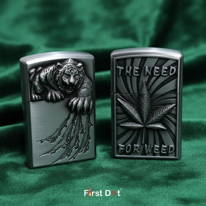 Two zippo lighters with tiger and cannabis leaf designs on a green fabric background.
