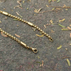 Gold chain bracelet on a textured surface with leaves First Dot Golden Ball Beaded Chain for Men 