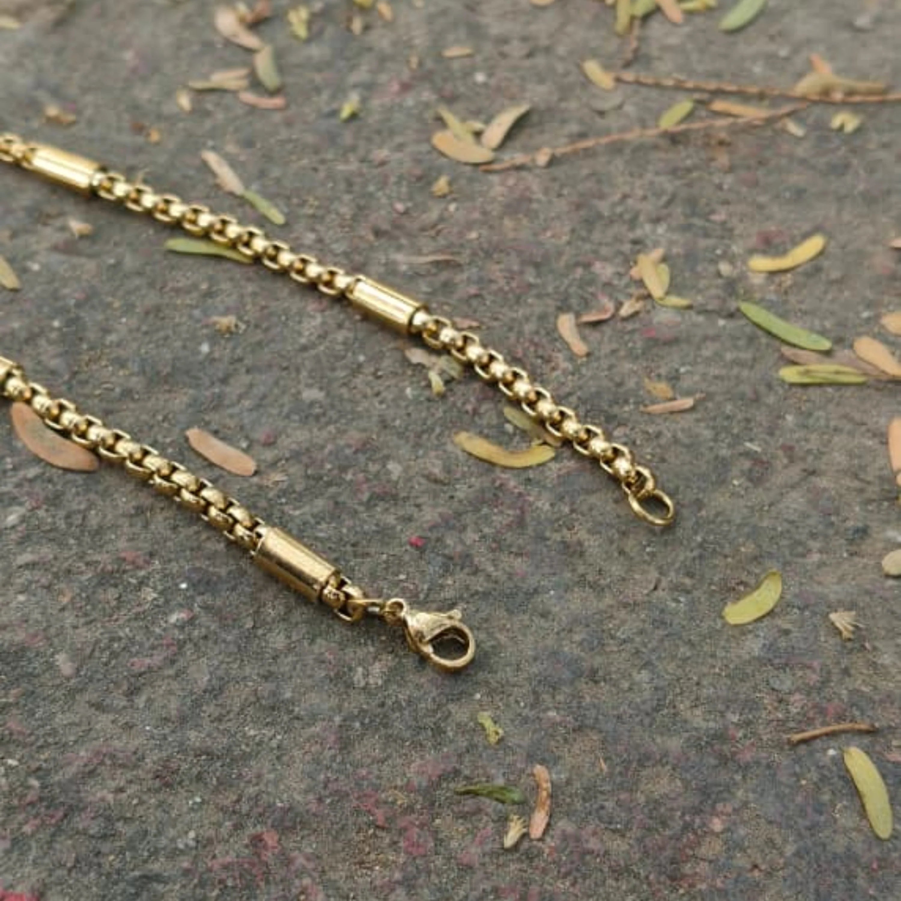 Gold chain bracelet on a textured surface with leaves First Dot Golden Ball Beaded Chain for Men 