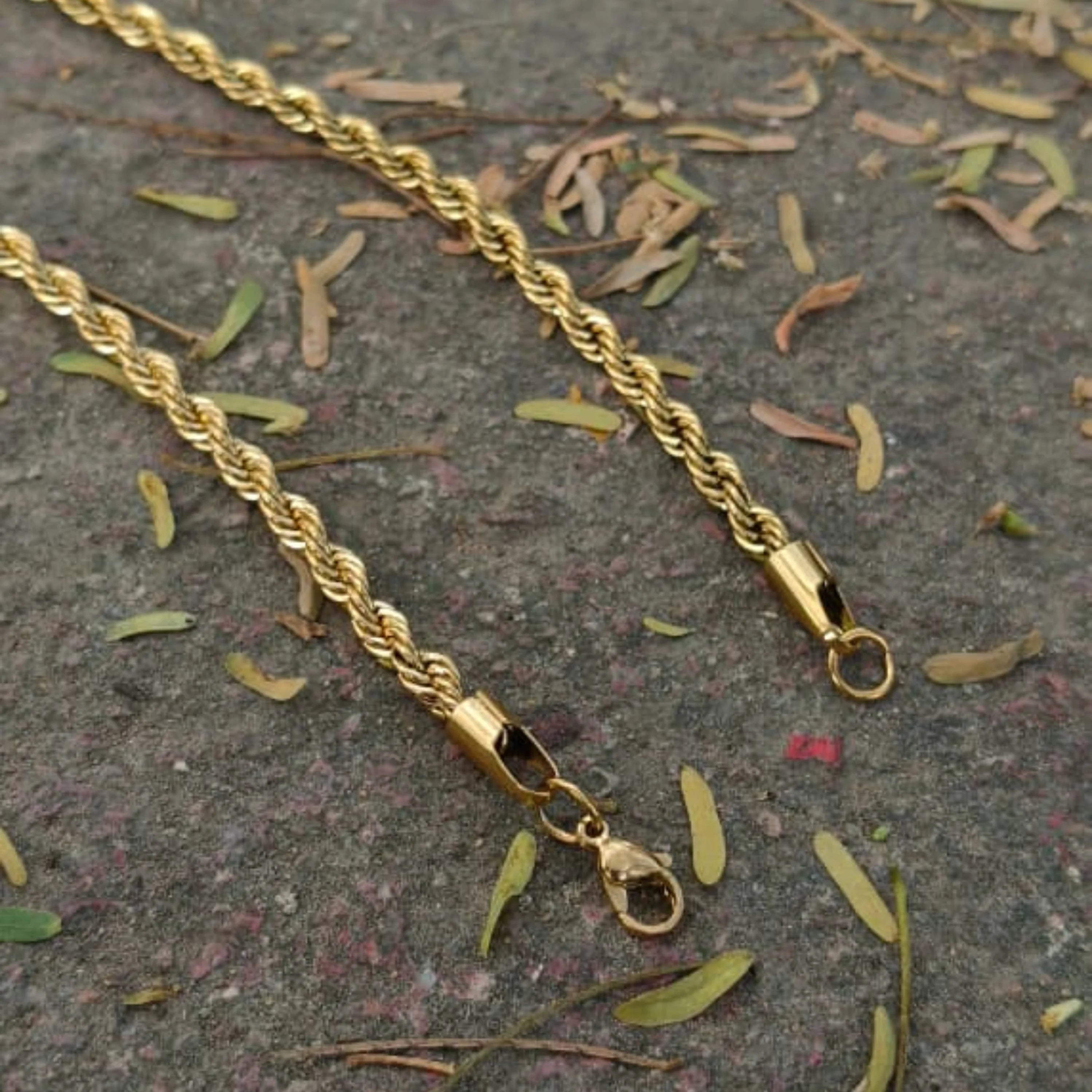 Gold rope chain necklace on a textured surface with dried leaves Golden Rope Chain for Men – Classic Stylish Necklace