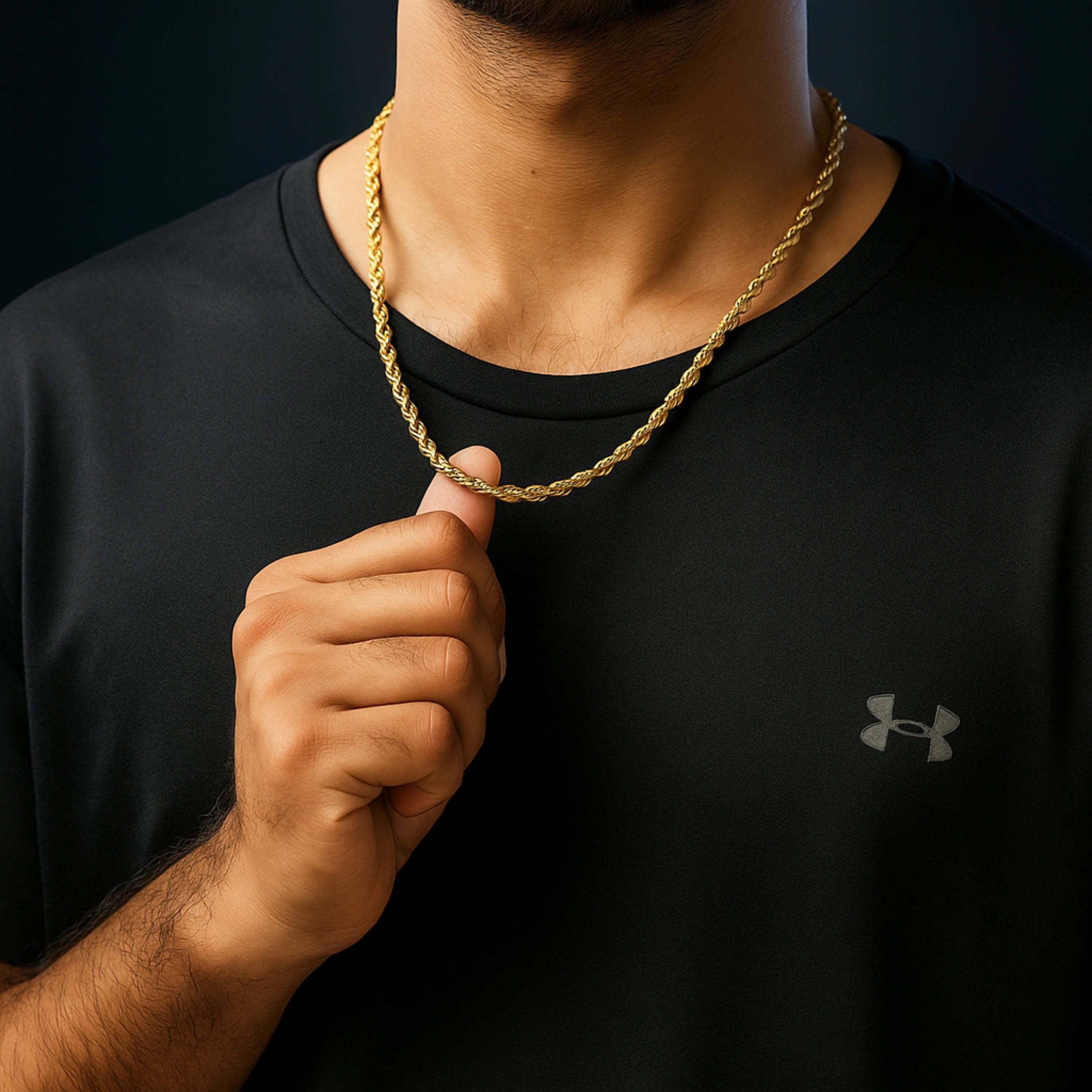 Person wearing a black Under Armour shirt with a gold chain necklace. Golden Rope Chain for Men – Classic Stylish Necklace