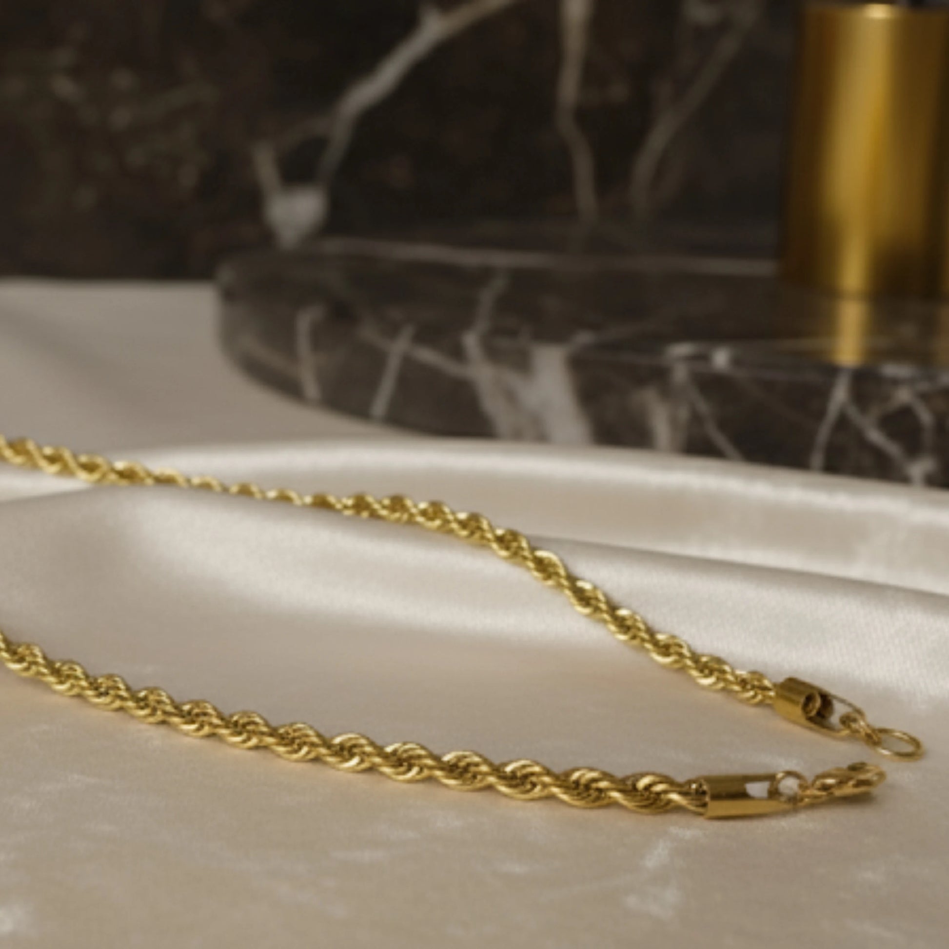 Gold chain on a marble surface with a blurred background Golden Rope Chain for Men – Classic Stylish Necklace