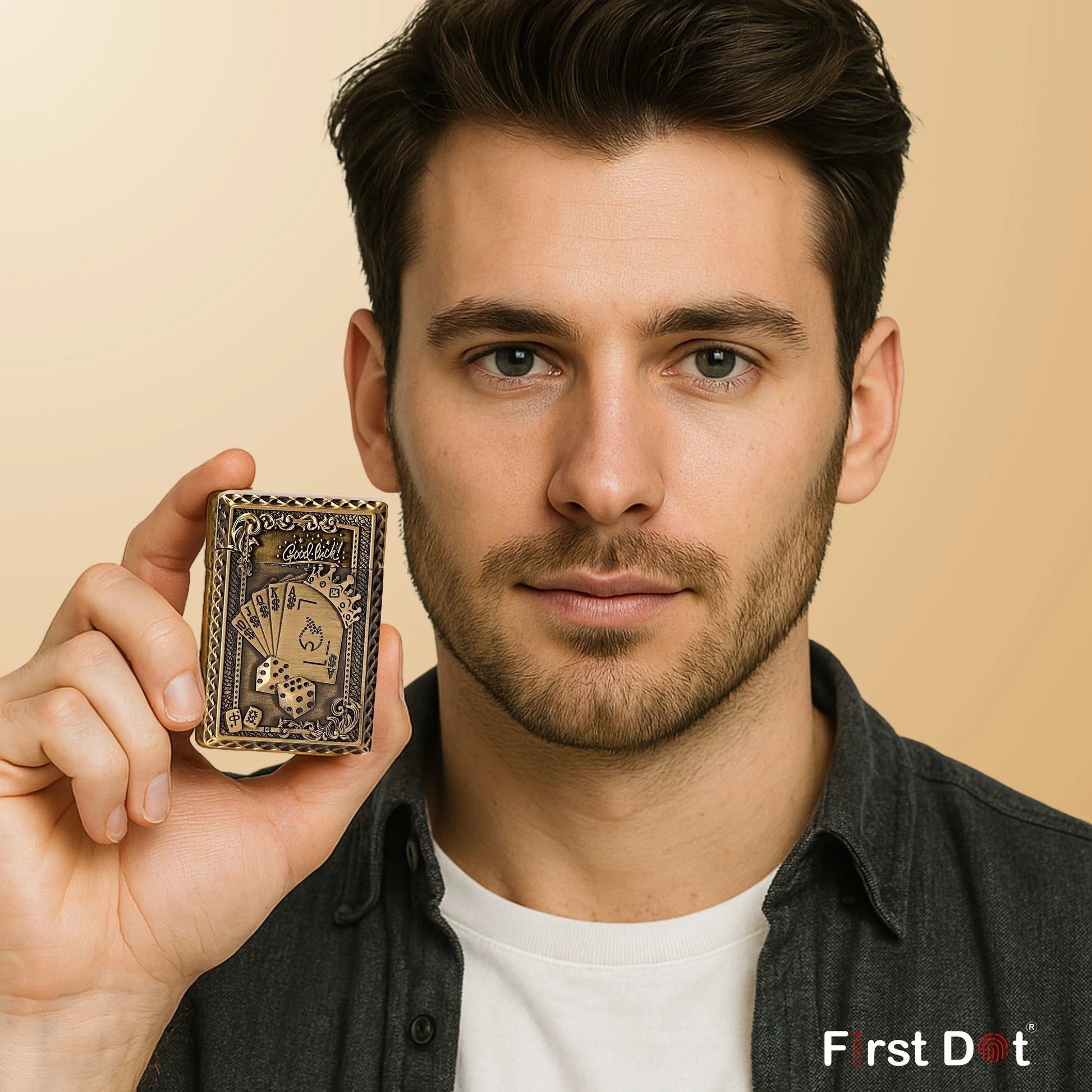 Man holding a small Good Luck Dice Embossed Premium Refillable Button Gas Lighter by First Dot with 'First Dot' branding against a beige background