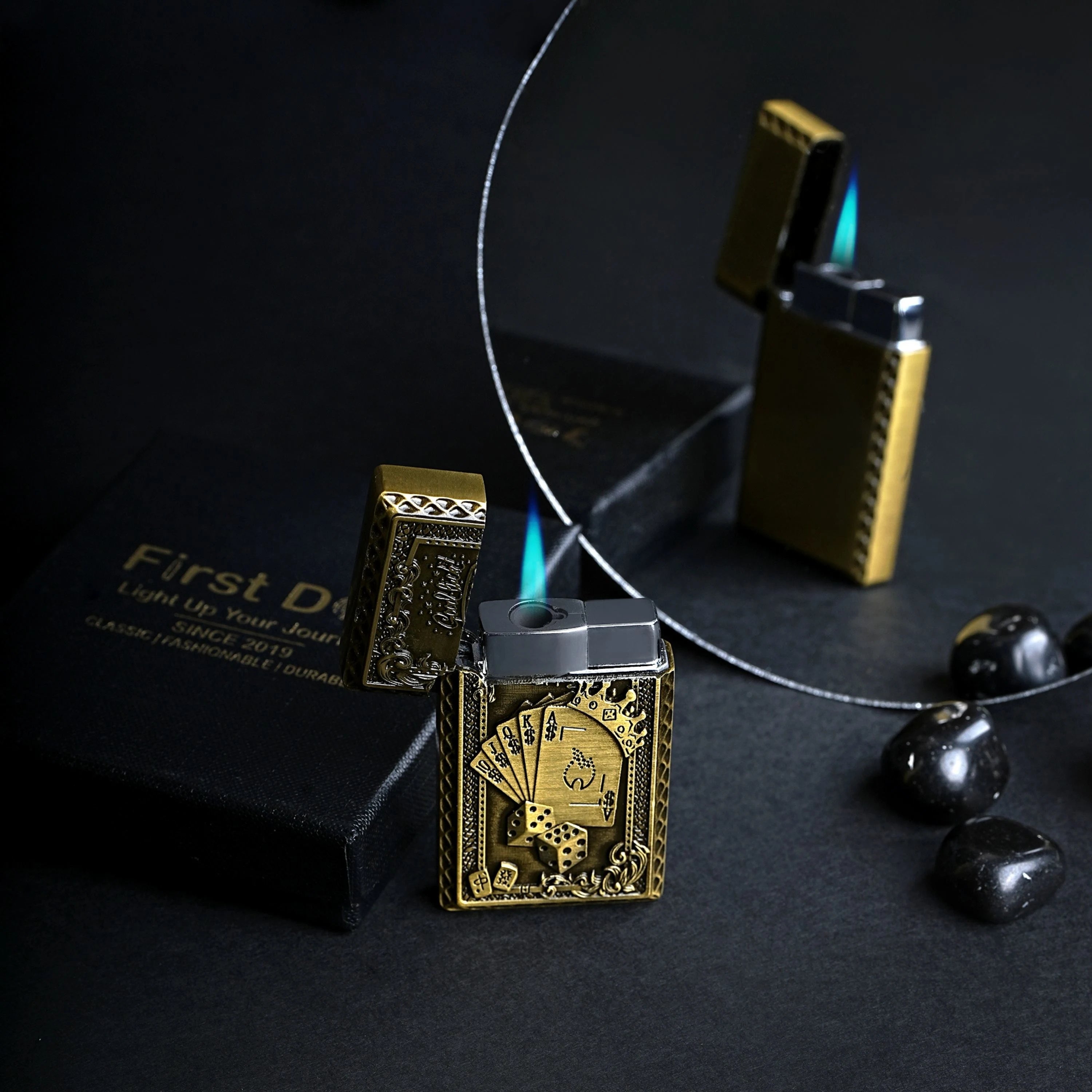 Gold lighter with playing card design on a dark surface Good Luck Dice Embossed Premium Refillable Button Gas Lighter by First Dot